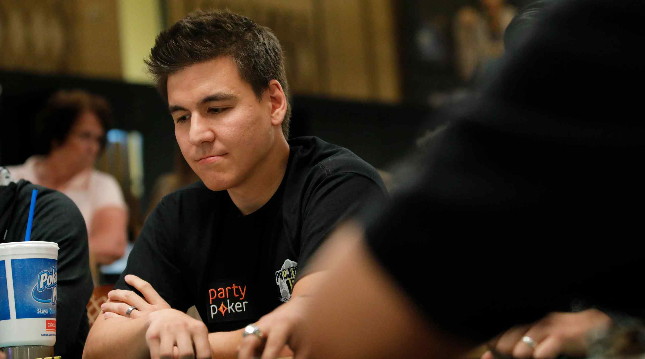 A photo of Jeopardy contestant James Holzhauer at a poker table.